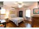 Inviting bedroom featuring wood floors, neutral walls, a comfortable bed, and natural light from two windows at 316 Gaithers Rd, Mansfield, GA 30055
