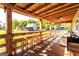 Spacious covered porch with bar stool seating and outdoor furniture, offering a view of the expansive property at 316 Gaithers Rd, Mansfield, GA 30055