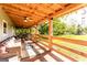 Comfortable covered porch with wicker seating and ceiling fan, perfect for enjoying the scenic outdoor views at 316 Gaithers Rd, Mansfield, GA 30055