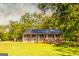 Inviting exterior view showcasing a rustic cabin with a spacious wooden porch and serene surroundings at 316 Gaithers Rd, Mansfield, GA 30055