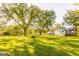 Scenic view of a country home with a sprawling green lawn and mature trees, offering a serene and inviting atmosphere at 316 Gaithers Rd, Mansfield, GA 30055