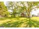 Idyllic country home featuring a well-manicured lawn and a charming covered porch surrounded by mature trees at 316 Gaithers Rd, Mansfield, GA 30055