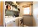 Laundry room featuring washer, dryer, shelving for storage, and a window at 316 Gaithers Rd, Mansfield, GA 30055
