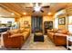 Open-concept living room offers a cozy atmosphere with wood accents, leather furniture, and fireplace at 316 Gaithers Rd, Mansfield, GA 30055