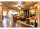 Open-concept living room with wood walls, wood floors, leather furniture, and wood burning stove at 316 Gaithers Rd, Mansfield, GA 30055
