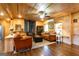 Spacious living room boasts wood walls, hardwood floors, fireplace, and comfortable seating at 316 Gaithers Rd, Mansfield, GA 30055
