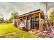 Exterior of a weathered shed with visible storage featuring a metal gate and assorted items at 316 Gaithers Rd, Mansfield, GA 30055