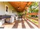 Spacious covered porch, featuring outdoor seating and a grill, perfect for relaxation and entertaining at 316 Gaithers Rd, Mansfield, GA 30055
