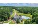 Stunning aerial view of a home with a pool, picturesque landscaping, and a serene lake, creating a private oasis at 415 Discovery Lake Dr, Fayetteville, GA 30215