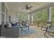 Relaxing back porch with comfortable wicker furniture, ceiling fan, and views of the lush backyard at 415 Discovery Lake Dr, Fayetteville, GA 30215