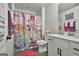 Bright bathroom featuring a vanity with storage and shower with a princess-themed curtain at 415 Discovery Lake Dr, Fayetteville, GA 30215