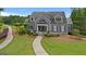 Charming exterior view showcases walkway, landscaped grounds, and inviting entrance, creating a welcoming curb appeal at 415 Discovery Lake Dr, Fayetteville, GA 30215