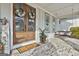 A cozy porch with brick floor and hanging swing, complemented by double doors with floral wreaths at 415 Discovery Lake Dr, Fayetteville, GA 30215
