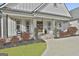 Inviting front porch with wooden pillars, decorative wreaths, and lush landscaping at 415 Discovery Lake Dr, Fayetteville, GA 30215