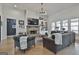 Cozy living room featuring a brick fireplace, hardwood floors, and modern furnishings at 415 Discovery Lake Dr, Fayetteville, GA 30215