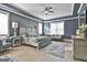 Comfortable main bedroom featuring a tray ceiling, a ceiling fan, and beautifully finished hardwood floors at 415 Discovery Lake Dr, Fayetteville, GA 30215