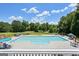 Relaxing pool area with ample seating, serene landscaping, and plenty of space, perfect for enjoying outdoor leisure at 415 Discovery Lake Dr, Fayetteville, GA 30215