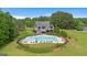 Beautiful home showcasing a large pool with plenty of seating and wooded view, perfect for outdoor relaxation and entertaining at 415 Discovery Lake Dr, Fayetteville, GA 30215