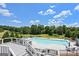 Beautiful pool with ample deck and seating space providing an ideal setting for relaxation, and enjoyment with a wooded view at 415 Discovery Lake Dr, Fayetteville, GA 30215