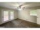 Well-lit bedroom with carpeted floors, a ceiling fan and a view of the backyard at 3375 Brenda Ln, Lithia Springs, GA 30122