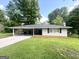 Charming single-story home with a spacious carport, mature trees and a well-maintained lawn at 3375 Brenda Ln, Lithia Springs, GA 30122