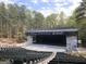 Outdoor amphitheater with rows of seats and a large stage surrounded by trees at 101 Sumner Place Ct, Peachtree City, GA 30269