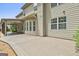 Covered back patio with outdoor dining and neutral exterior at 101 Sumner Place Ct, Peachtree City, GA 30269