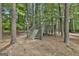 Wooden playset nestled among mature trees in a wooded backyard at 101 Sumner Place Ct, Peachtree City, GA 30269