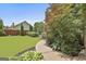 Well-manicured lawn with lush landscaping and mature trees surrounding home at 101 Sumner Place Ct, Peachtree City, GA 30269