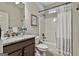 Clean bathroom features granite counters and a shower with a white curtain at 101 Sumner Place Ct, Peachtree City, GA 30269