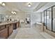 Luxurious bathroom with dual vanity, tiled floors, garden tub, walk-in shower, and access to bedroom at 101 Sumner Place Ct, Peachtree City, GA 30269