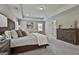Bedroom with tray ceiling, a beautifully decorated bed, carpet floors, and neutral walls and window shutters at 101 Sumner Place Ct, Peachtree City, GA 30269