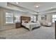 Spacious bedroom featuring natural light, neutral walls, carpet floors, and a tray ceiling at 101 Sumner Place Ct, Peachtree City, GA 30269