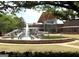 Beautiful fountain with modern art and manicured landscaping in front of clubhouse at 101 Sumner Place Ct, Peachtree City, GA 30269