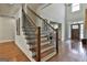 Staircase featuring wood steps with metal railings leads to the foyer at 101 Sumner Place Ct, Peachtree City, GA 30269