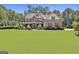 Beautiful stone-and-siding home with a large, manicured lawn and a charming covered front porch at 101 Sumner Place Ct, Peachtree City, GA 30269