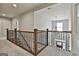 Bright upstairs hallway with iron railing and natural light at 101 Sumner Place Ct, Peachtree City, GA 30269
