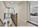Hallway on the second floor of the home with carpet, wooden railings and doorways to rooms at 101 Sumner Place Ct, Peachtree City, GA 30269