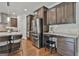 Modern kitchen with stainless steel appliances, granite countertops, and an island with bar stools at 101 Sumner Place Ct, Peachtree City, GA 30269