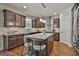 Open kitchen features granite counters, wooden cabinets and stainless steel appliances at 101 Sumner Place Ct, Peachtree City, GA 30269