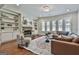 Bright living room with a stone fireplace, built-in shelving, and a comfortable seating area at 101 Sumner Place Ct, Peachtree City, GA 30269
