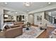 Open-concept living room with seamless flow to the kitchen, hardwood floors and comfortable seating at 101 Sumner Place Ct, Peachtree City, GA 30269