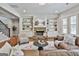 Spacious living room featuring built-in shelves, a fireplace, and a cozy seating arrangement at 101 Sumner Place Ct, Peachtree City, GA 30269