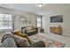 Living room featuring a floral rug, neutral walls, carpet, a sofa, and modern decor at 101 Sumner Place Ct, Peachtree City, GA 30269