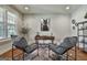 Modern office with a rustic desk, neutral chairs, and stylish decor at 101 Sumner Place Ct, Peachtree City, GA 30269