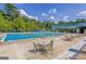 Community pool with lap lanes, tables and chairs, and building in the background at 101 Sumner Place Ct, Peachtree City, GA 30269