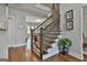 Elegant staircase with hardwood steps, decorative iron railing, and natural light at 101 Sumner Place Ct, Peachtree City, GA 30269