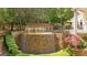 Stunning backyard pool featuring a rock waterfall feature and professionally landscaped garden at 8957 Old Southwick Pass, Johns Creek, GA 30022