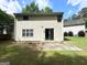 View of the home's backyard featuring green grass, concrete patio and sliding glass doors at 3814 Clear Lake Nw Way, Acworth, GA 30101
