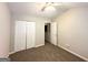 Bedroom featuring neutral carpet, ceiling fan, and large closet behind double doors at 3814 Clear Lake Nw Way, Acworth, GA 30101